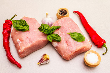 Raw pork meat loin with fresh vegetables and dry spice