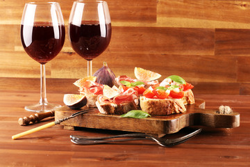 Tasty savory tomato Italian appetizers, or bruschetta on slices of toasted baguette garnished with basil