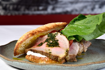 beef sandwich with rucula, cherry tomatoes and pesto