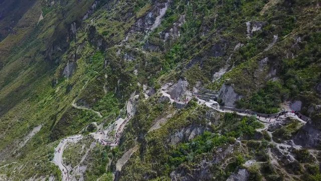 Aerial shot stairs staircase down to Quilotoa, Ecuador caldera in the Andes Mountains.