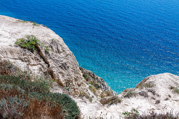 View of the sea from a very steep shore, rocks.