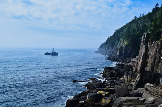 Boat in the Bay of Fundy Offshore Digby Peninsula Rock Formations Nova Scotia Canada on Cloudy Day