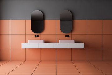 Gray and orange tile bathroom, double sink