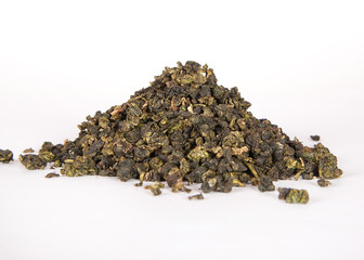 Black dry tea leaves isolated on white background