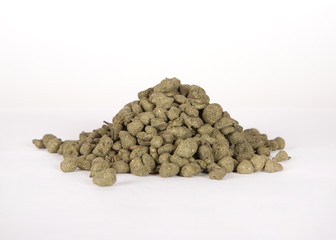 Black dry tea leaves isolated on white background