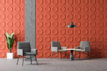 Orange office lounge with armchairs and tables