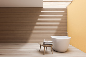 Fototapeta na wymiar Spacious yellow and wooden bathroom with tub
