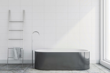 White tile bathroom interior with tub and ladder