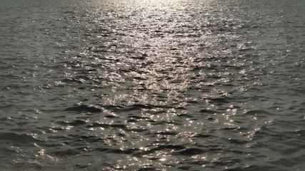 View of a deep  sea rippling water surface reflecting the sunlight.