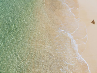 beautiful sandy beach with turquoise water and soft blue foaming ocean wave. Tropical background and travel concept