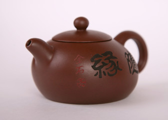 brown old isolated clay teapot on white background with hieroglyphs