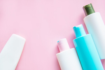 makeup cosmetics white jars on pink uniform background