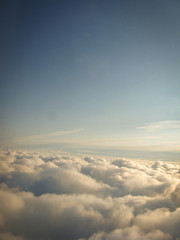 The endless horizon of the sky above the clouds. Great view from the plane window while traveling. - obrazy, fototapety, plakaty