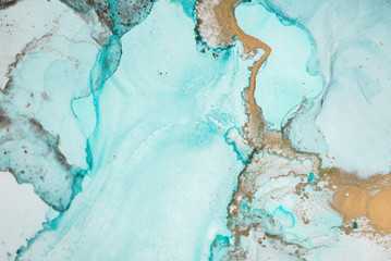 The picture is painted in alcohol ink. Creative abstract artwork made with translucent ink colors. Trendy wallpaper. Abstract painting, can be used as a background for wallpapers, posters, websites.