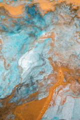 The picture is painted in alcohol ink. Creative abstract artwork made with translucent ink colors. Trendy wallpaper. Abstract painting, can be used as a background for wallpapers, posters, websites.