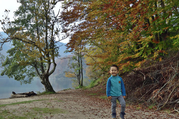 Cute boy traveling in Plitvice National Park, Croatia, in the fall