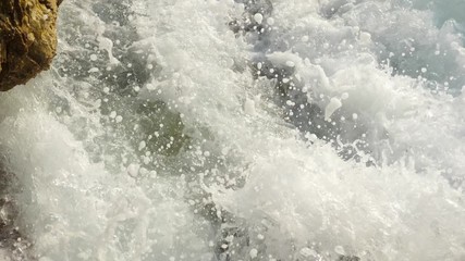 Sea waves crashing on stone beach. Slow motion sea waves crashing. 