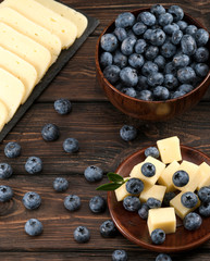 cheese with blueberries on a wooden background