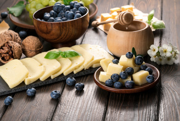 cheese with blueberries on a wooden background