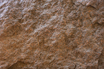 The structure of red and black granite. The texture of natural stone. Creative vintage background.