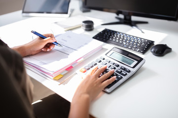 Businesswoman Calculating Bill