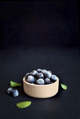 Fototapeta na wymiar Blueberries Black background. Berries