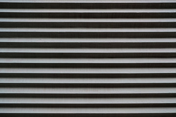 Narrow horizontal stripes in dark and light gray tones.