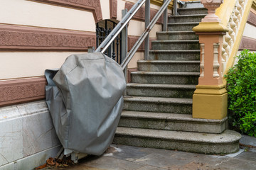 Disabled chair lift in a cover outside a historic building