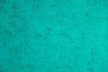 The structure of concrete is green. Creative vintage background. Structural plaster. Modern lights in the form of a white ball on a long wire.