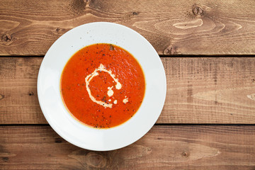 Tomato soup viewed from above. A classic comfort food, tomato soup is often enjoyed near summer end or fall. It is a simple and healthy soup using ripe tomatoes, broth and cream sometimes added.