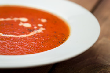 Tomato soup closeup view. A classic comfort food, tomato soup is often enjoyed near summer end or fall. It is a simple and healthy soup using ripe tomatoes, broth and cream sometimes added.
