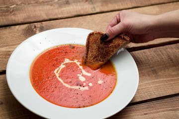 Grilled cheese and tomato soup. A classic comfort food, tomato soup is often enjoyed near summer end or fall. It is a simple and healthy soup using ripe tomatoes, broth and cream sometimes added.