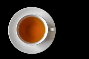 Filled Cup of tea on black background.