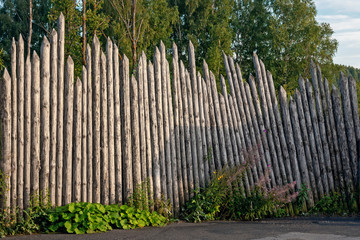a very old wooden fence made of logs is a good example of ancient architecture
