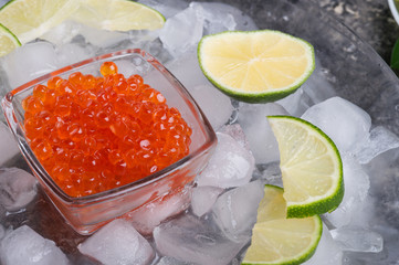  fresh red  salmon caviar with lime around ice. macro shot.  Protein luxury delicacy  healthy food