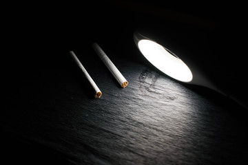 Two cigarettes under the lamp