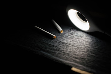 Two cigarettes under the lamp