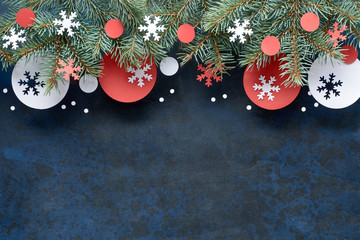 Christmas background with fir twigs, red and white paper decorations