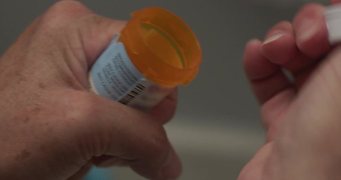 Senior woman with prescription drugs. Medication pill bottle