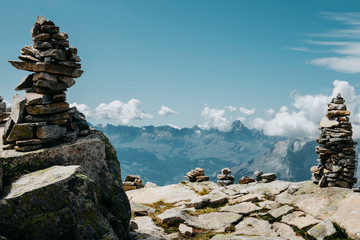 Scenic Alps mountain panorama. Journey Travel Trek and real life concept. Tourism idea with copy space. Beautiful nature. Rest in the mountains. Autumn in Alps in green and white colors. Rock totems