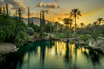 Aerial view of the sunset over Sachne or Gan Hashlosha oasis, with popular waterfall in Northern...