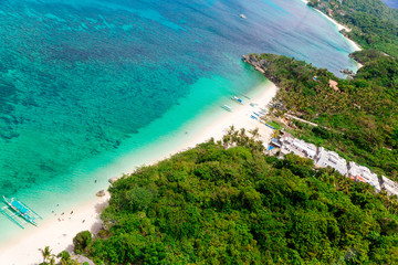 Aerial view from the drone on the landscape tropical island with  turquoise sea with boats, palm trees and hotels. Summer vacation concept.