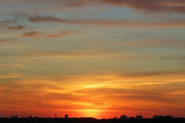 Beautiful orange golden sunset background over the city