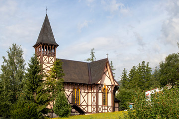 Fototapeta na wymiar Typical church in foothill area. Sunny day in Stary Smokovec, High Tatras.