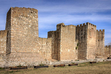 Naklejka premium Ancient Smederevo fortress stone walls and smooth clouds on a blue sky