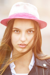 close up portrait of beautiful stylish kid girl in hat