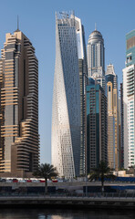 Obraz premium DUBAI, UAE - may 2019: View of modern skyscrapers shining in sunrise lights in Dubai Marina in Dubai, UAE.