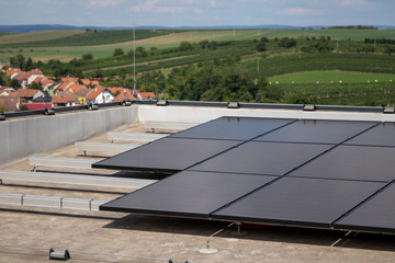 Solar panels at the top of the building. Solar modules on a flat roof.