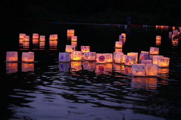 Magical moment of Water lanterns flowing down stream