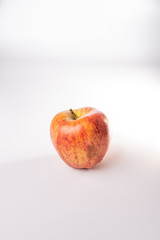 Red and orange Fuji apple isolated against a white background